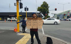 Shay Kenny vows to stand holding his sign for eight hours a day for at least the next week.