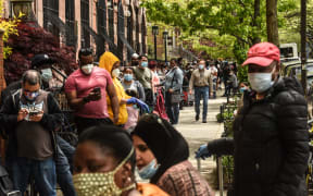 NEW YORK, NY - MAY 15: People wait on a long line to receive a food bank donation at the Barclays Center on May 15, 2020 in the Brooklyn borough in New York City.