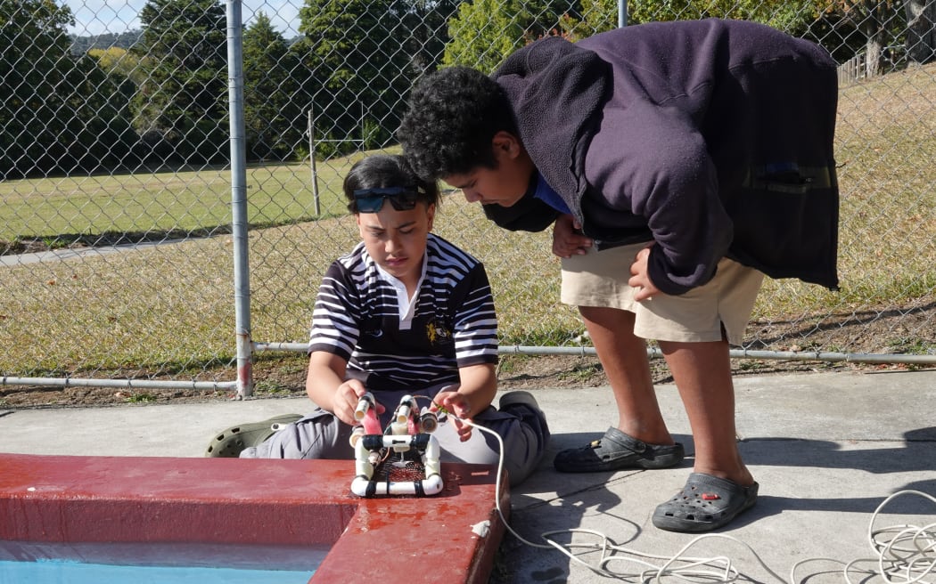 Motatau 12-year-olds Te Maioha Tipene, left, and Zacchaeus Tua test their aquabot in the school pool.