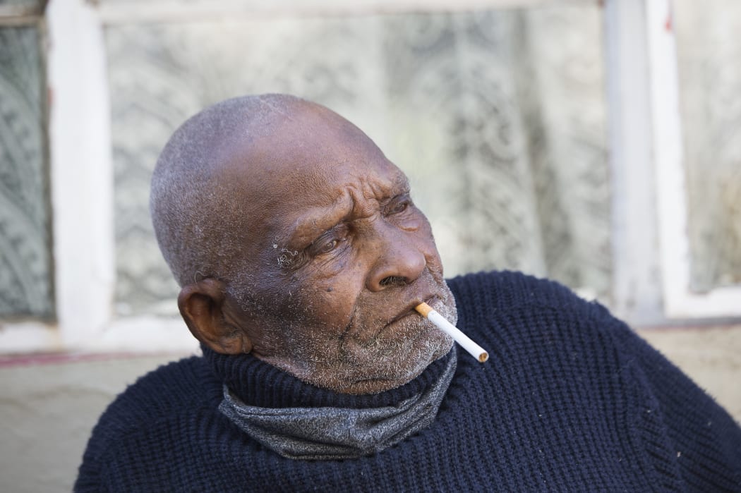 Fredie Blom enjoys a cigarette as he celebrates his 116th birthday at his home in Delft, near Cape Town, on May 8, 2020.