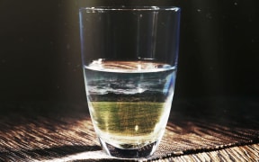 A glass of water showing a farm