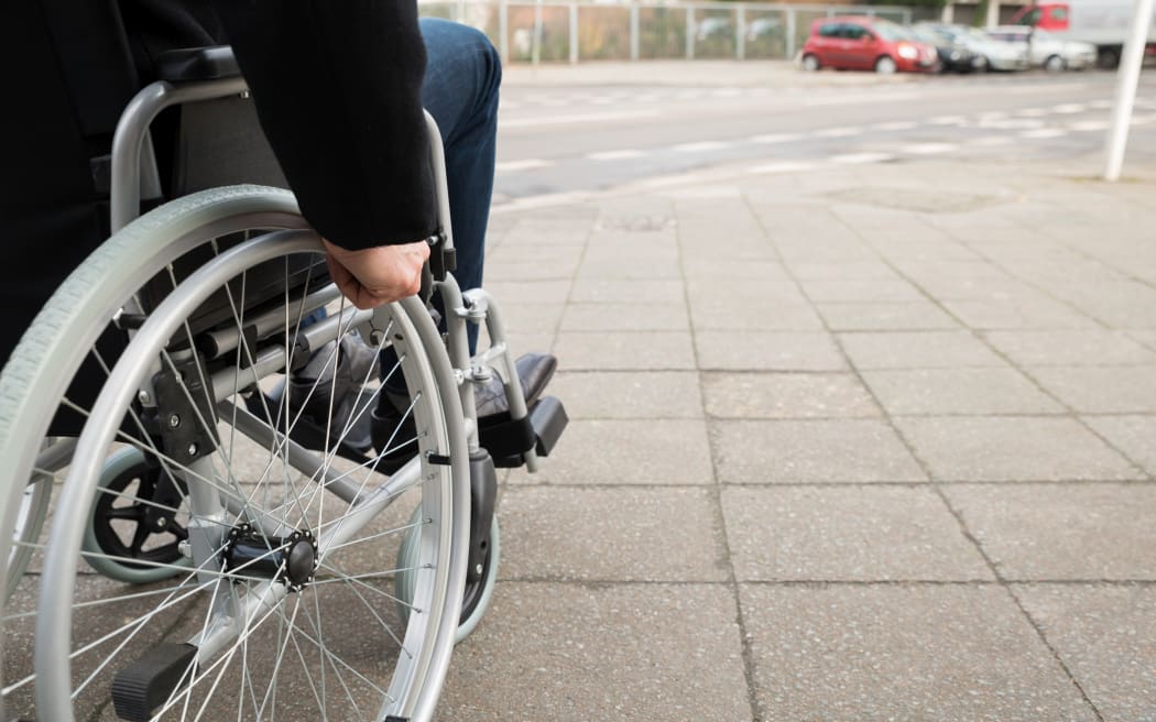 Close-up Of Disabled Man Sitting On Wheelchair