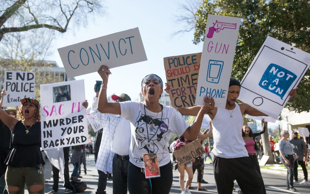 Black Lives Matter protesters march through the streets in response to the police shooting of Stephon Clark.