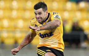 The Hurricanes' James Marshall kicks a penalty.