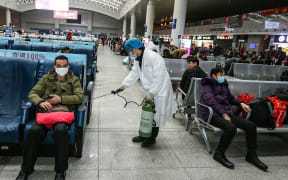 A worker disinfecting the waiting area at a railway station in Nanchang, in China's central Jiangxi province. 22 January.