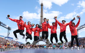 Members of Japan's figure skating team pose with their medals, following the reallocation of medals from the Beijing 2022 Olympic Winter Games, at the Champions Park at Trocadero during the Paris 2024 Olympic Games.