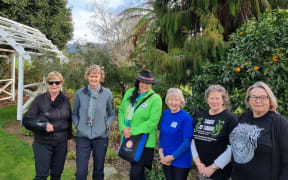 From Left - Maryann Eason, Jude Tisdall, Tiaki Ormsby, Janet Leggett, Nardene Berry, and Jo Wrigley, at Eason's farm homestead with Maungatautari Sanctuary Mountain behind.