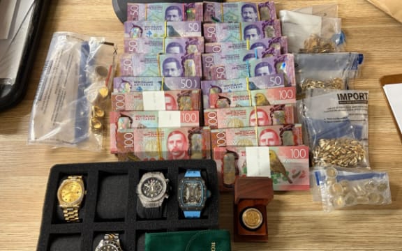 Semi-automatic rifles, alcohol and cash have been seized as part of an operation targeting the Hells Angels.