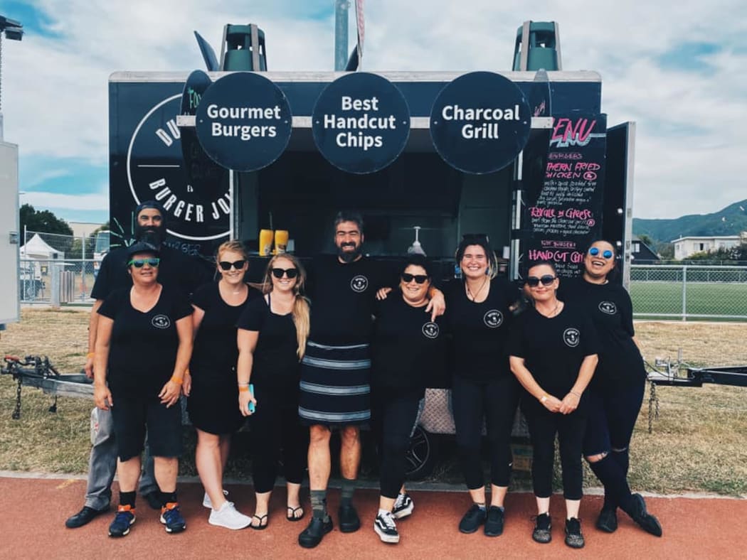 Food truck operators Karli Mitchell (centre right) and her partner Rutger Richter (centre left) have had to cancel travel plans due to Covid killing their income, and just want a refund they were promised on their travel.