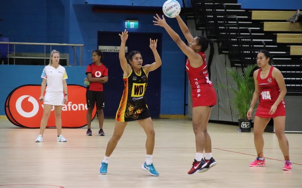 Action from the Tonga (red) and Papua New Guinea game in Suva