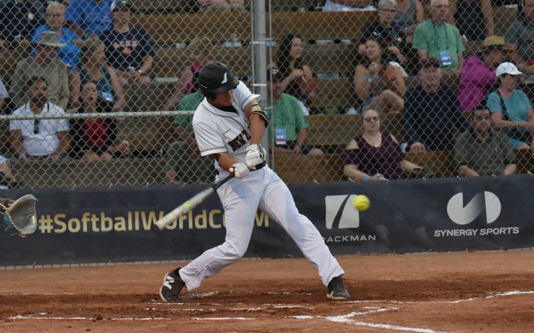 New Zealand Black Sox captain Cole Evans drives in a run in the top of the fifth inning against Argentina at the WBSC World Cup in Prince Albert, Canada.