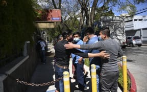 People remain outside the Ministry of Foreign Affairs in Guatemala City on January 25, 2021, after giving details of their relatives who might be in the group among people found burned to death on a rural road in the state of Tamaulipas, Mexico.