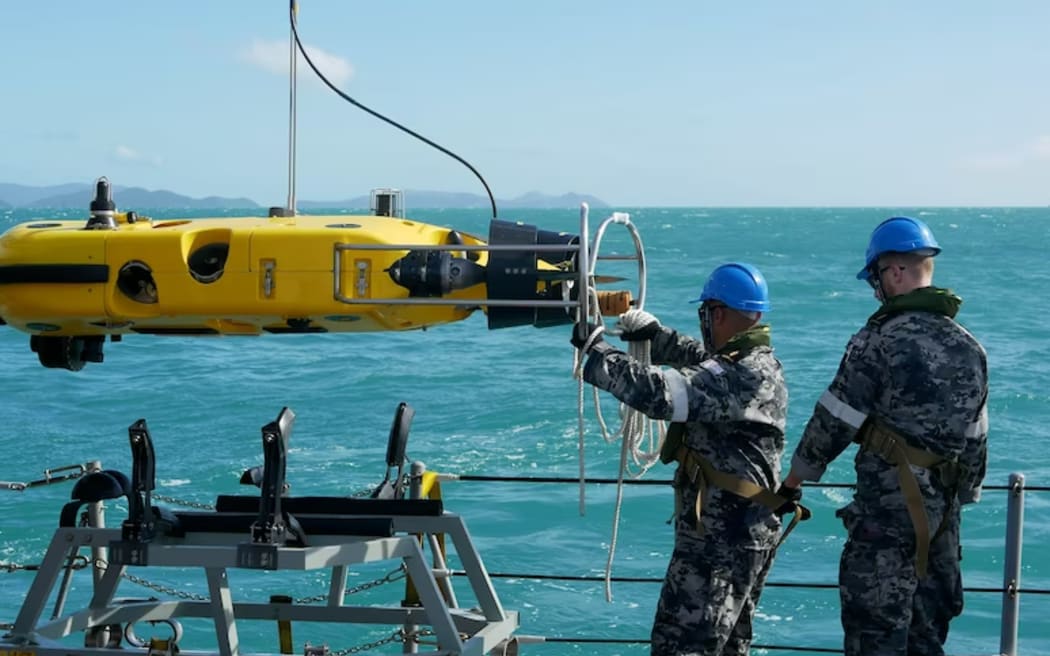 Royal Australian Navy sailors from HMAS Huon conduct search operations in the vicinity of Lindeman Island, Queensland.