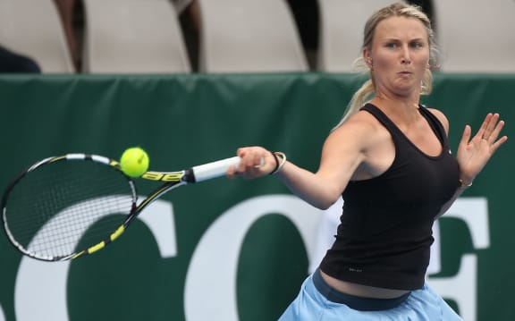 Tennis player Sacha Jones in action.