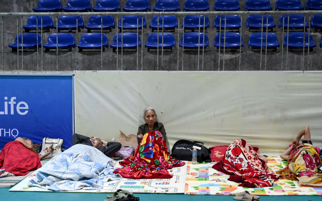 People take shelter inside the Nghe An Provincial Gymnasium in Vinh city before Typhoon Kajiki makes landfall in Vietnam.