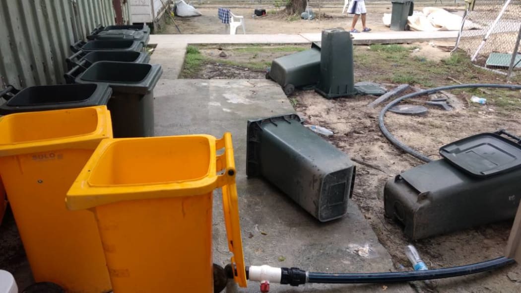 Overturned rubbish bins used to store rainwater.