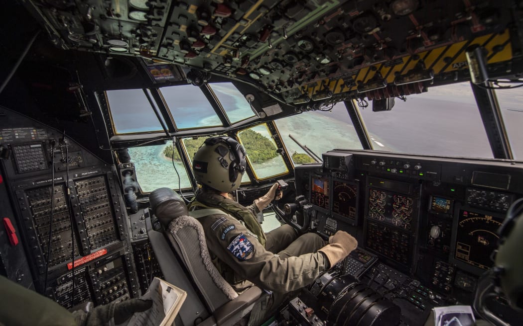 Pilot FLTLT Michal-Louise Paget flies over Etal Atoll, Chuuk, Micronesia as part of Operation Christmas Drop.