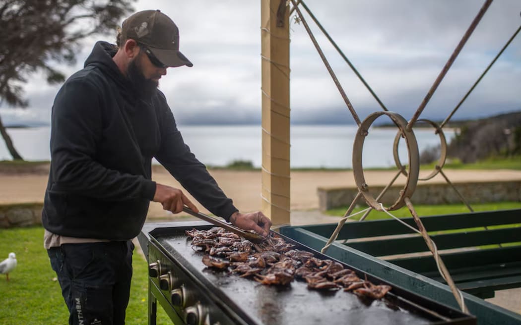Aaron Maynard cooks mutton birds, caught last season and frozen for the months ahead.