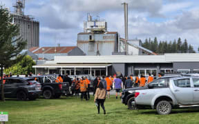 Workers heading into the Winstone Pulp International meeting after the closure of two of its mills.