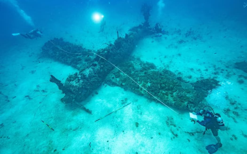 Marine scientists assess the wreck of a sunken WWII aircraft in Chuuk Lagoon. (Supplied: Ranger Walter)