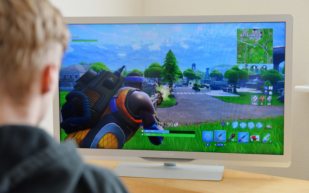 A boy plays Fortnite.