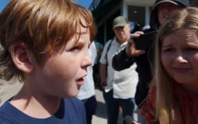 Weston Halsne said a friend who shielded him from gunfire was shot in the back as they hid under the pews.