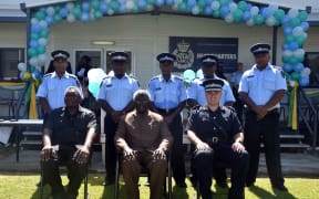 The five new RSIPF Officers  (standing) being deployed on the UN Peacekeeping Mission to Sudan with the Prime Minister, Hon. Manasseh Sogavare (sitting centre), Minister of Police, National Security and Correctional Services, Hon. Moses Garu (sitting left) and the Commissioner, Matthew Varley.