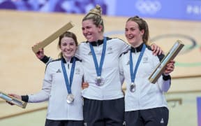 Picture by Alex Whitehead/SWpix.com - 04/08/2024 -  Paris 2024 Olympic Games - Track Cycling - National Velodrome, Saint-Quentin-en-Yvelines, France - Women’s Team Sprint - New Zealand: Rebecca Petch, Shaane Fulton, Ellesse Andrews on the podium receiving the Olympic Silver Medal