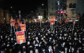 Ultra-Orthodox Jewish youths take part in a protest against Israeli army conscription in Jerusalem on January 6, 2026. (Photo by Ilia YEFIMOVICH / AFP)