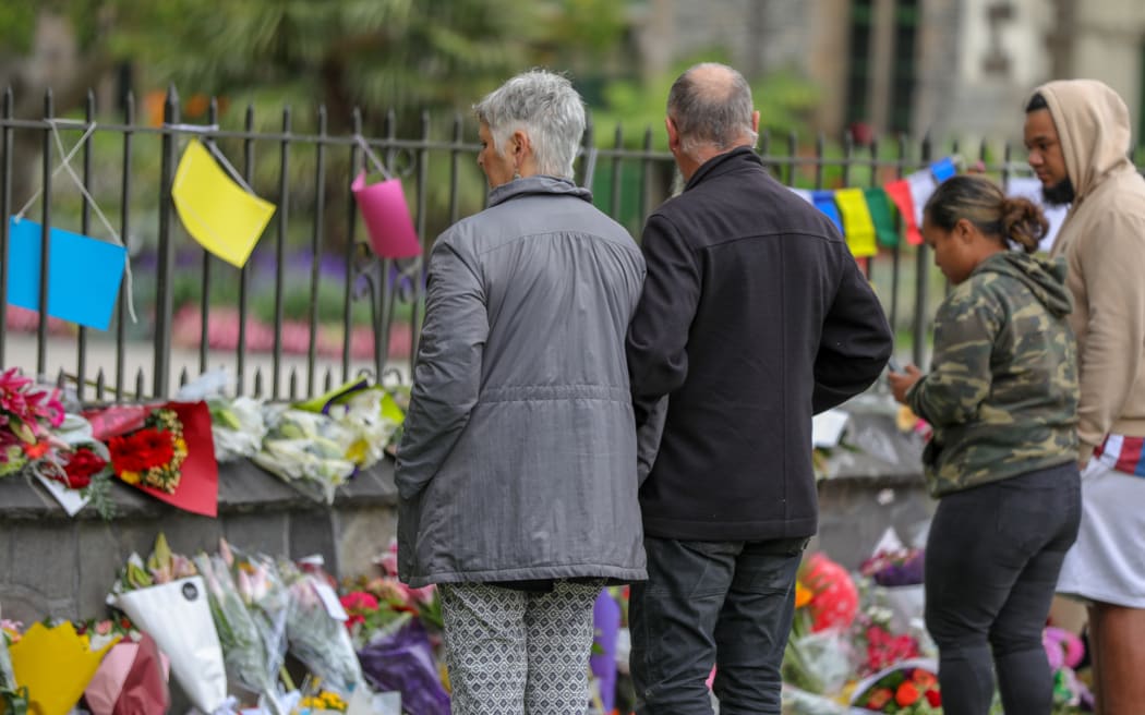 Christchurch otanic garden wall with hundreds of flowers laid in memory of those lost in the mosque shooting
