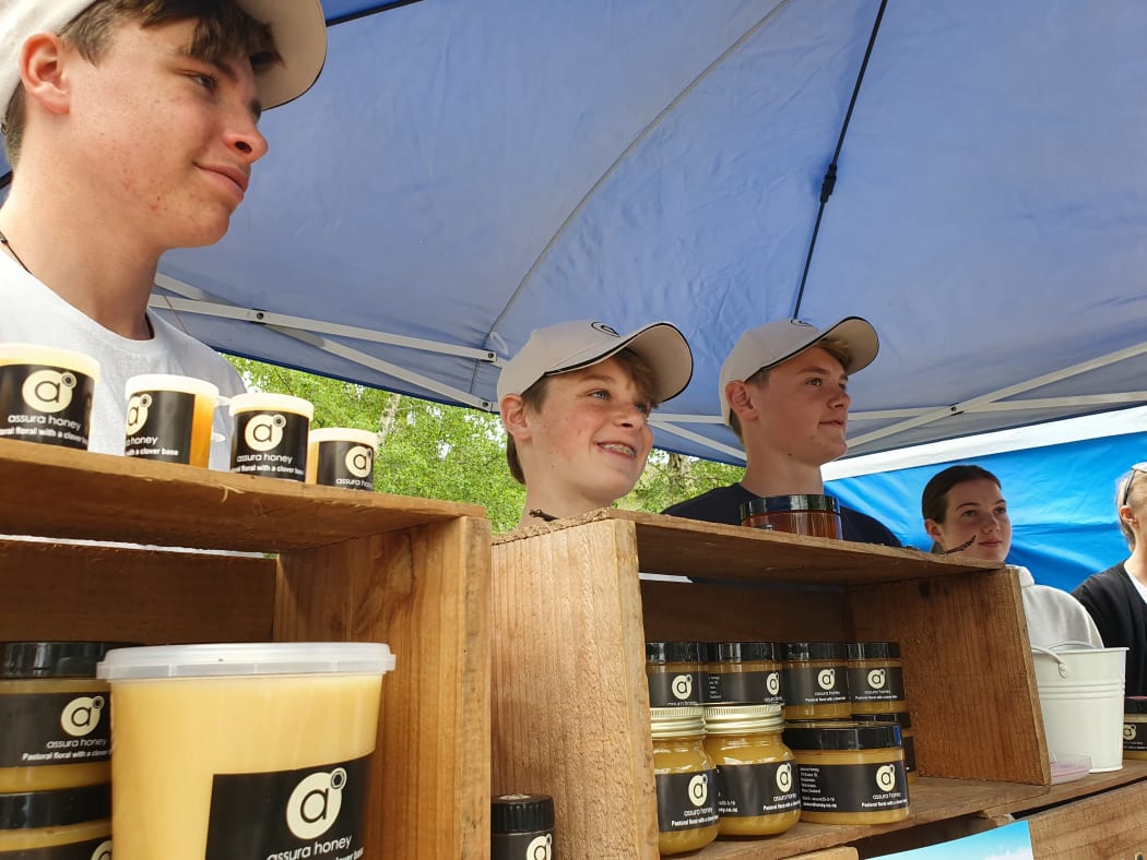 Thomas Williams and George and Freddie Eschenbach (L-R) manning the honey stall