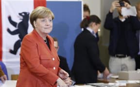 German Chancellor Angela Merkel casts her vote.