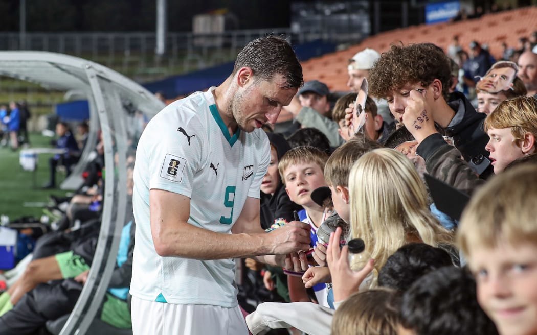 New Zealand's Chris Wood signs autographs.