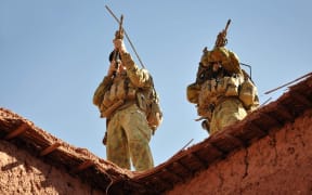 A handout photo released by Australian Department of Defence on October 21, 2009 shows Australian soldiers from the Special Operations Task Group using their rifle scopes to investigate the surrounding mountains during an operation in southern Afghanistan.