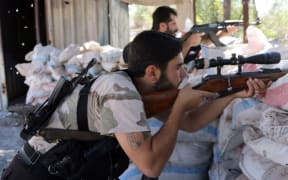 Fighters from a moderate Syrian opposition faction made up of former Syrian Free Army fighters man a position near Aleppo in September 2014.
