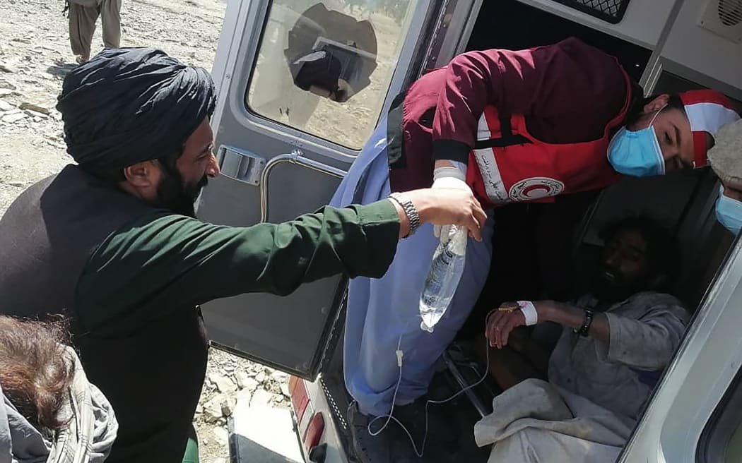 Afghan Red Crescent Society giving medical treatment to a victim following an earthquake in Afghanistan's Gayan district, Paktika province on 22 June, 2022.
