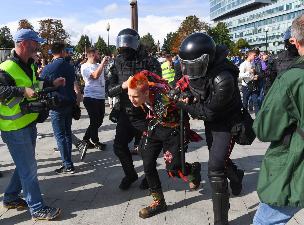 Police in Moscow detain a protester during the rally in support of the registration of independent candidates for the September's elections.