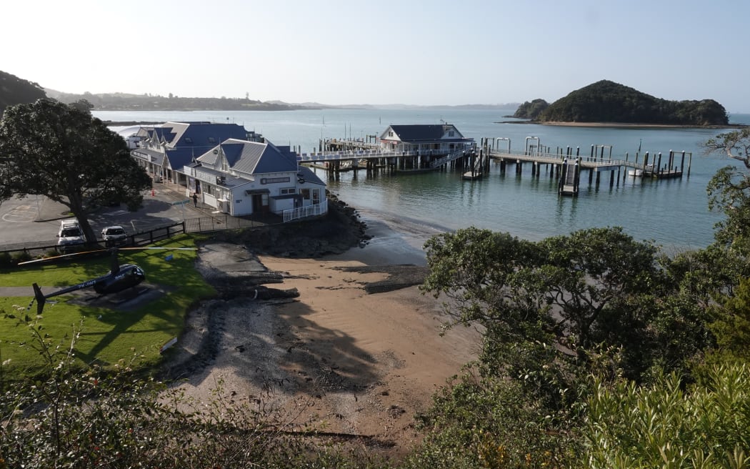 View of Paihia from Maiki/Lookout Hill, with Salt Air helicopter pad, Maritime Building, Paihia wharf and Motumaire Island, Paihia, Bay of Islands.