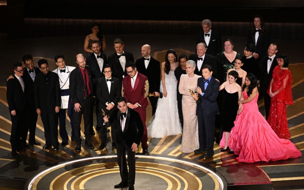 US film producer Jonathan Wang (C) accepts the Oscar for Best Picture for "Everything Everywhere All at Once" onstage during the 95th Annual Academy Awards at the Dolby Theatre in Hollywood, California on March 12, 2023. (Photo by Patrick T. Fallon / AFP)