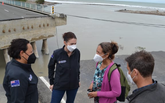 From left: Emergency Management minister and East Coast MP Kiri Allan, Prime Minister Jacinda Ardern, Te Kura Kaupapa Māori o Nga Taonga Tuturu ki Tokomaru tumuaki Herena Paranihi and the Prime Minister's fiance Clarke Gayford speak about the flood damage.