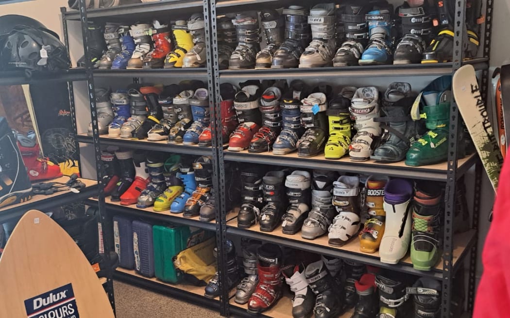 Photo of shelves full of skiboots.