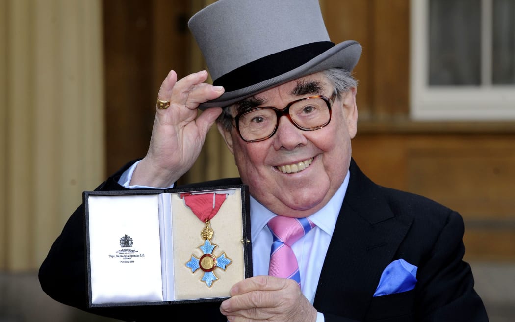 Ronnie Corbett poses with his medal after he received the CBE honour from the Queen in 2012