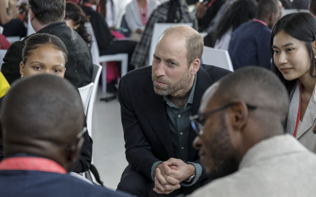 Britain's Prince William (C), Prince of Wales, listens to a group of young people at the Earthshot Prize Climate Leaders Youth Programme at Rooftop on Bree in Cape Town, on November 4, 2024. (Photo by GIANLUIGI GUERCIA / POOL / AFP)