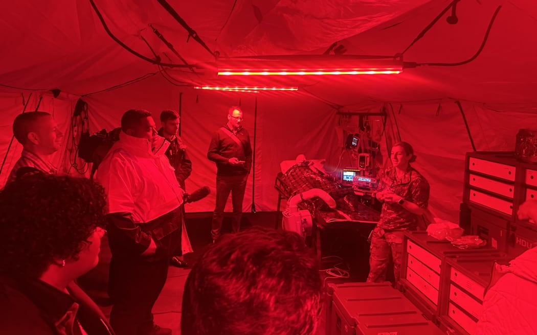 Representatives from Fiji and Samoa health and emergency services listen to a presentation by NZDF personnel on a deployable operating theater. The red lights can be switched on and off and are for maintaining a low profile in tactical situations. (Red light travels less far than white light) Trentham Military Base, Upper Hutt, Wellington 27 October 2023