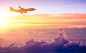 Airplane in the sky at sunrise