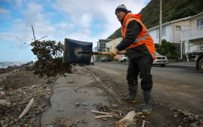 Worker cleaning up the mess left from high southerly seas this week.