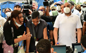 A woman argues with Forensic National Institute morgue employees for delays on information on their relatives after the Jet Set nightclub roof collapsed in Santo Domingo on April 11, 2025. Grief-stricken Dominicans began holding funerals for loved ones who were among at least 220 people killed in a nightclub rooftop collapse, even as dozens remained unaccounted for. (Photo by MARTIN BERNETTI / AFP)