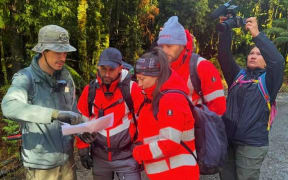 Rob Parsons (left) with searchers looking for Celine Cremer in bushland in Tasmania's north-west in December.