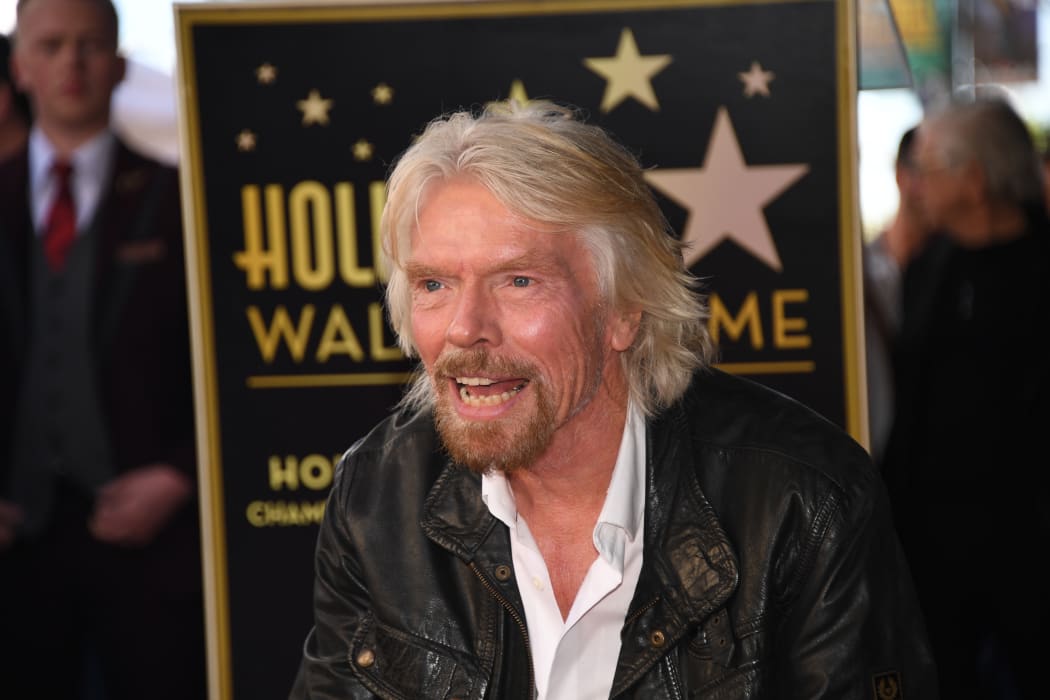 Sir Richard Branson poses on his star at his Hollywood Walk of Fame star unveiling ceremony, October 16, 2018 in Hollywood, California.