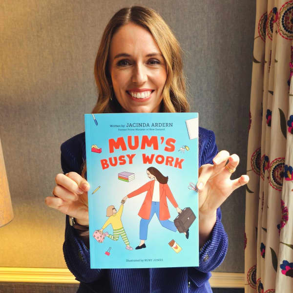 Jacinda Ardern with her children's book Mum's Busy Work.